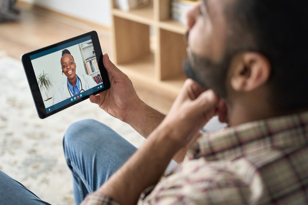 Man speaking to a doctor virtually on his tablet