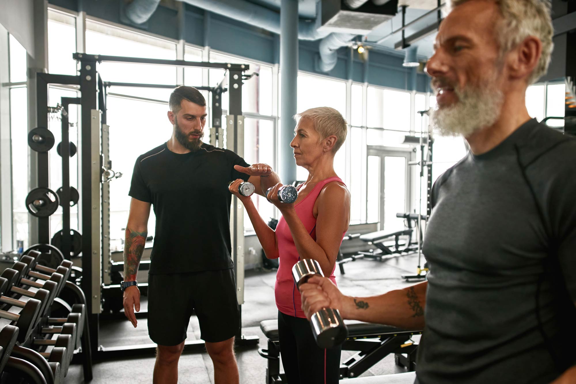 Mature man and woman training with a personal trainer