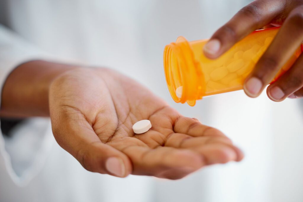 Closeup of pouring a pill into a palm