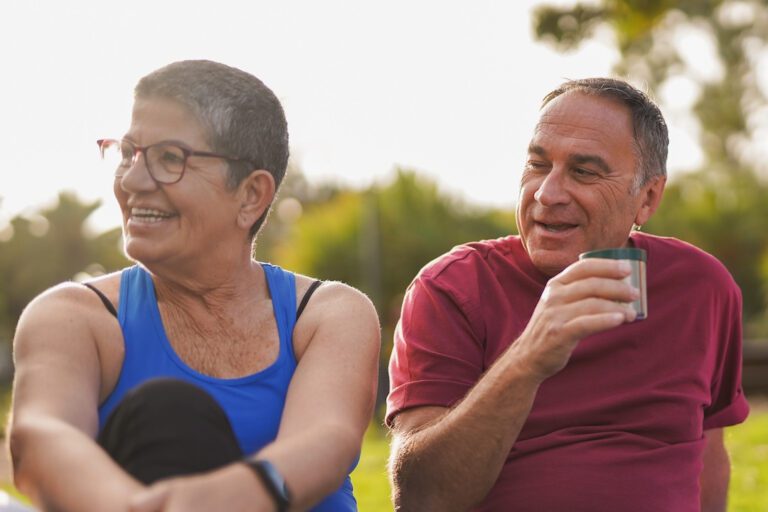 Senior couple sitting in a park after workout