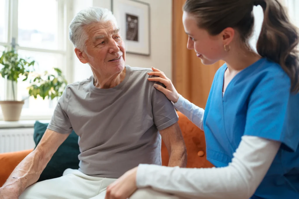 elderly man talking to nurse at home