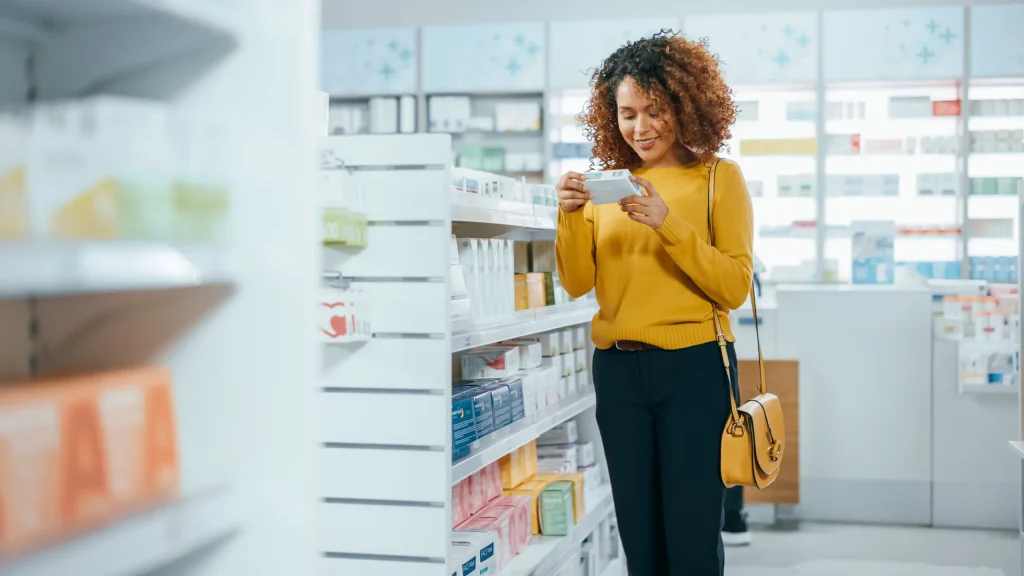 woman in pharmacy looking at medication