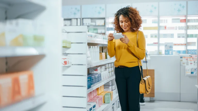 woman in pharmacy looking at medication