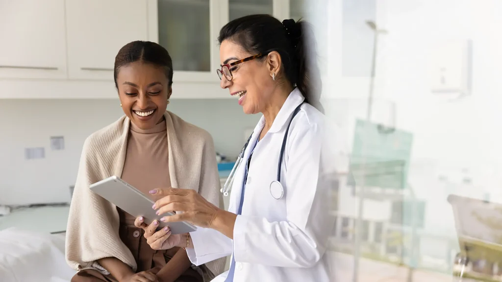 doctor looking at chart with patient