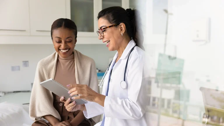 doctor looking at chart with patient